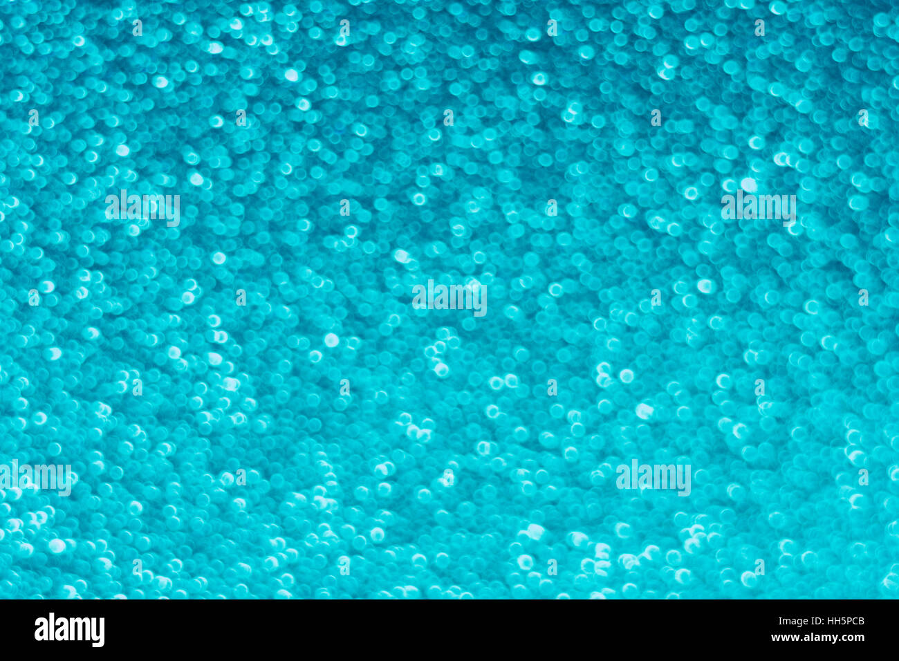 Abstract al di fuori della messa a fuoco dei punti blu che appaiono come piccole bolle - in realtà la superficie di un pezzo di plastica testurizzata. Foto Stock