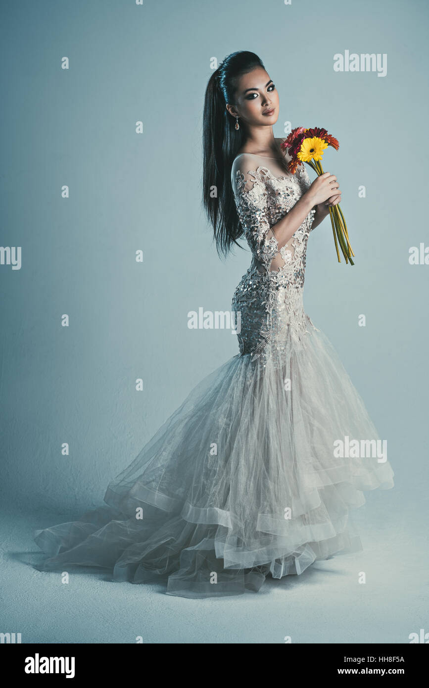 Giovane donna asiatica in abito con fiori ritratto di moda Foto Stock