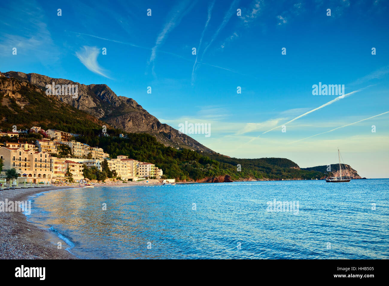 Sveti Stefan spiaggia di sabbia e vista città nei pressi di Budva, Montenegro. Balcani, mare Adriatico, l'Europa. Tramonto Foto Stock