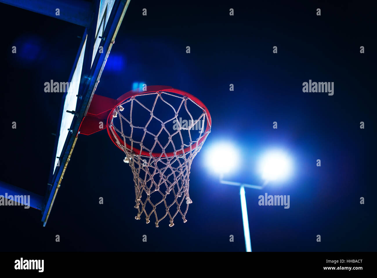 Basketball hoop sullo sport corte di notte con lens flare Foto Stock