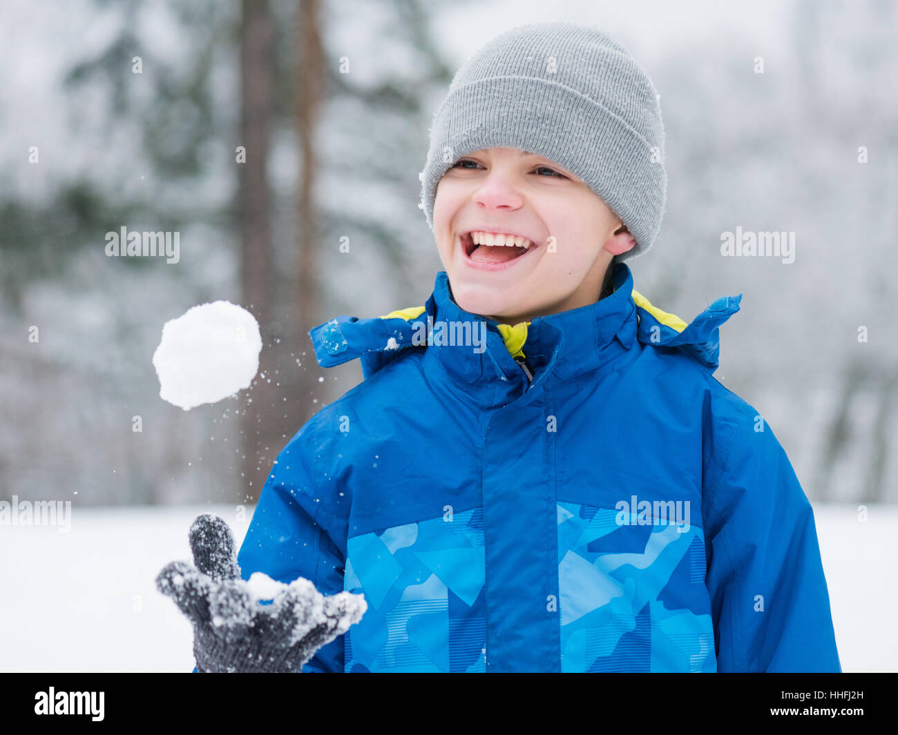 Bambino giocare nella neve sul giorno di inverno Foto Stock