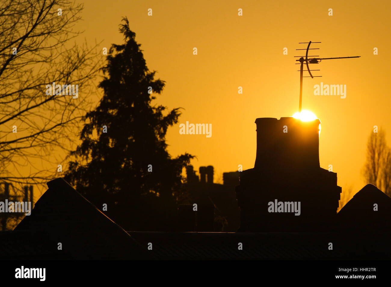 A nord di Londra, Regno Unito. Xx gen, 2016. Sagome di camini a golden glow sunrise su North London Credit: Dinendra Haria/Alamy Live News Foto Stock