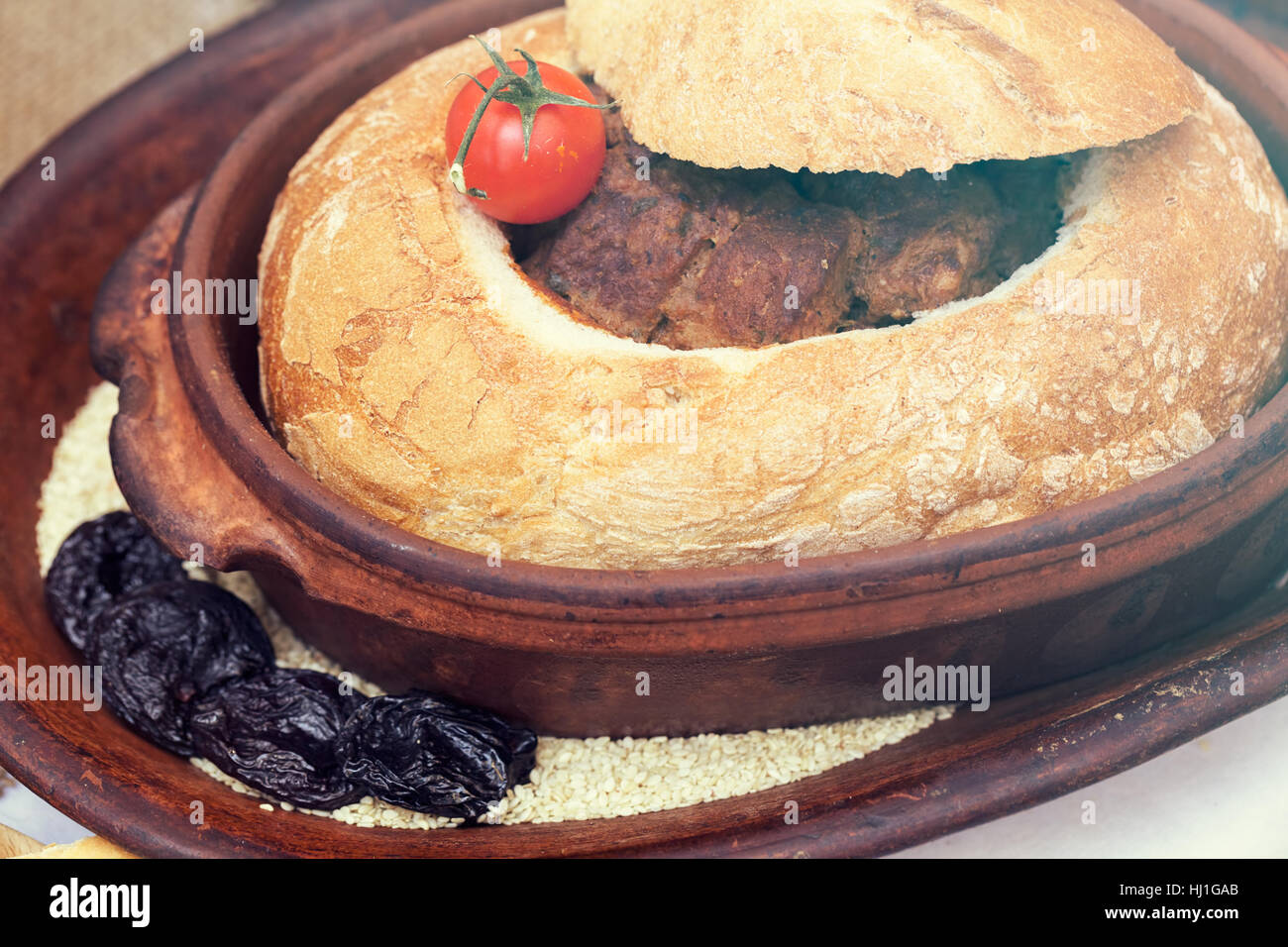 Gulasch in un pane su una piastra di argilla Foto Stock