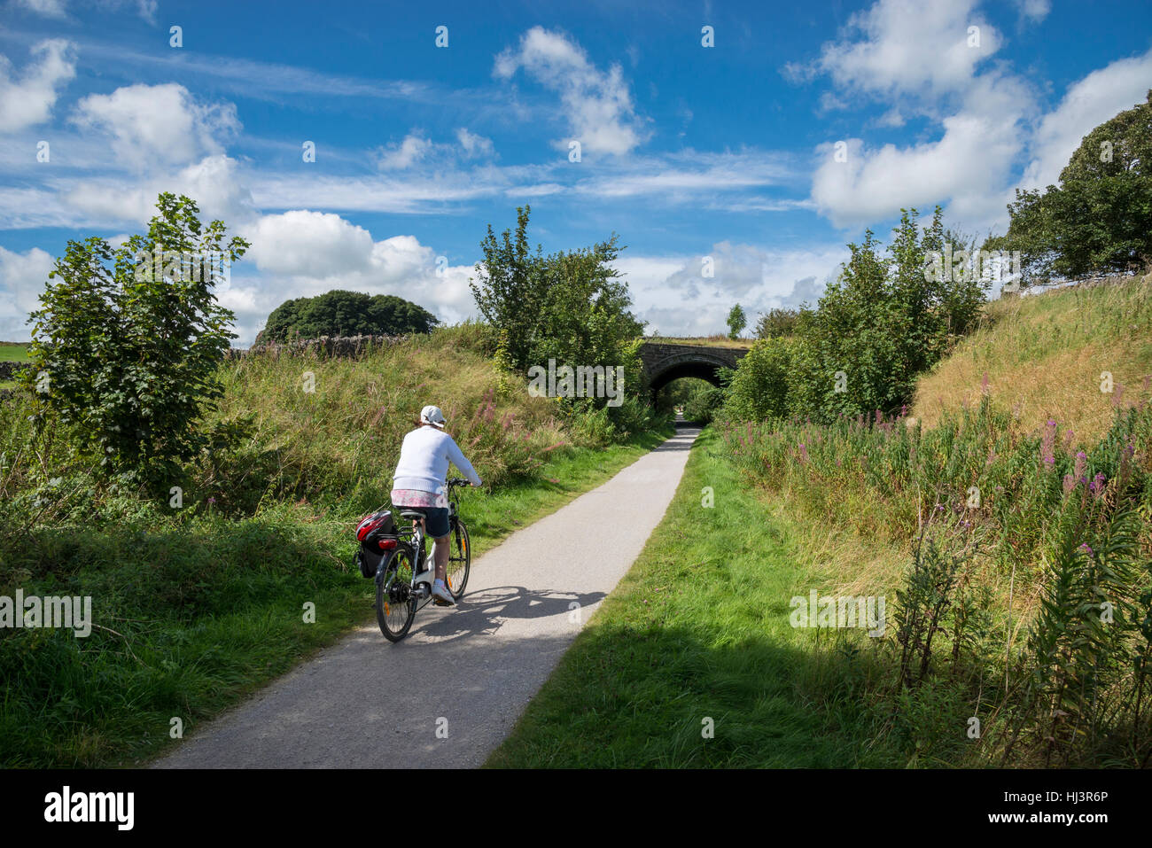 Donna in bicicletta sulle Tissington Trail nel parco nazionale di Peak District, Derbyshire, in Inghilterra. Foto Stock