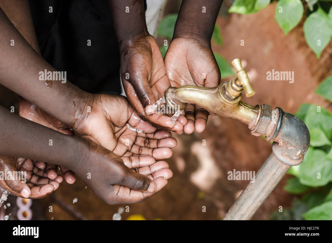 Bambino nero le mani sotto acqua africana tocca problema mondiale Foto Stock
