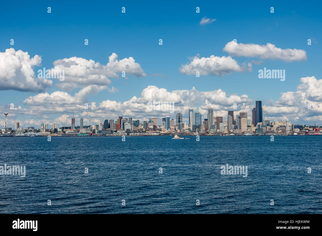 Puffy bianche nuvole passare il puntatore del mouse sopra la skyline di Seattle in una giornata di sole. Foto Stock