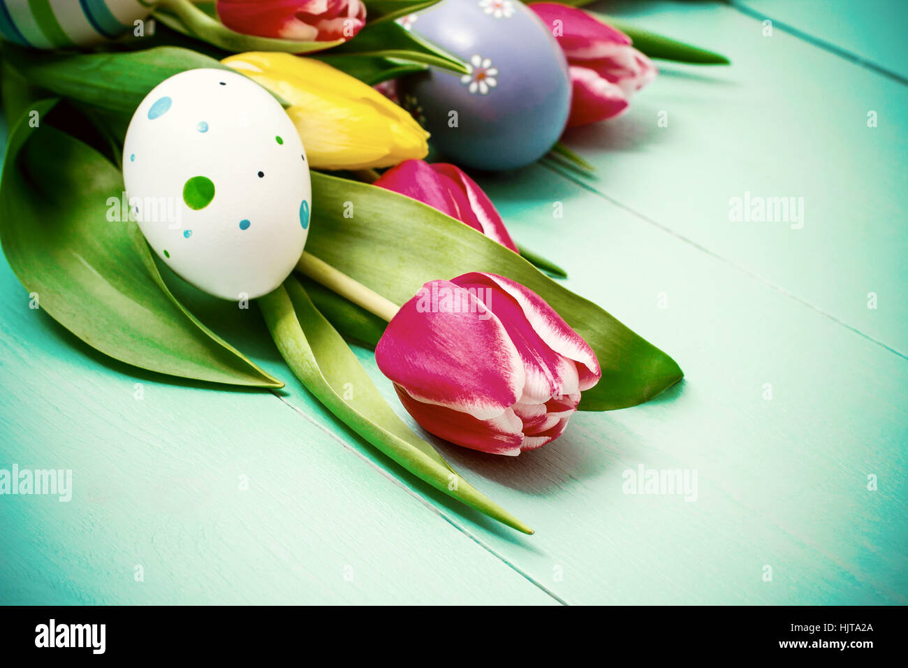 Rosso e tulipani gialli con colorate uova di Pasqua Foto Stock