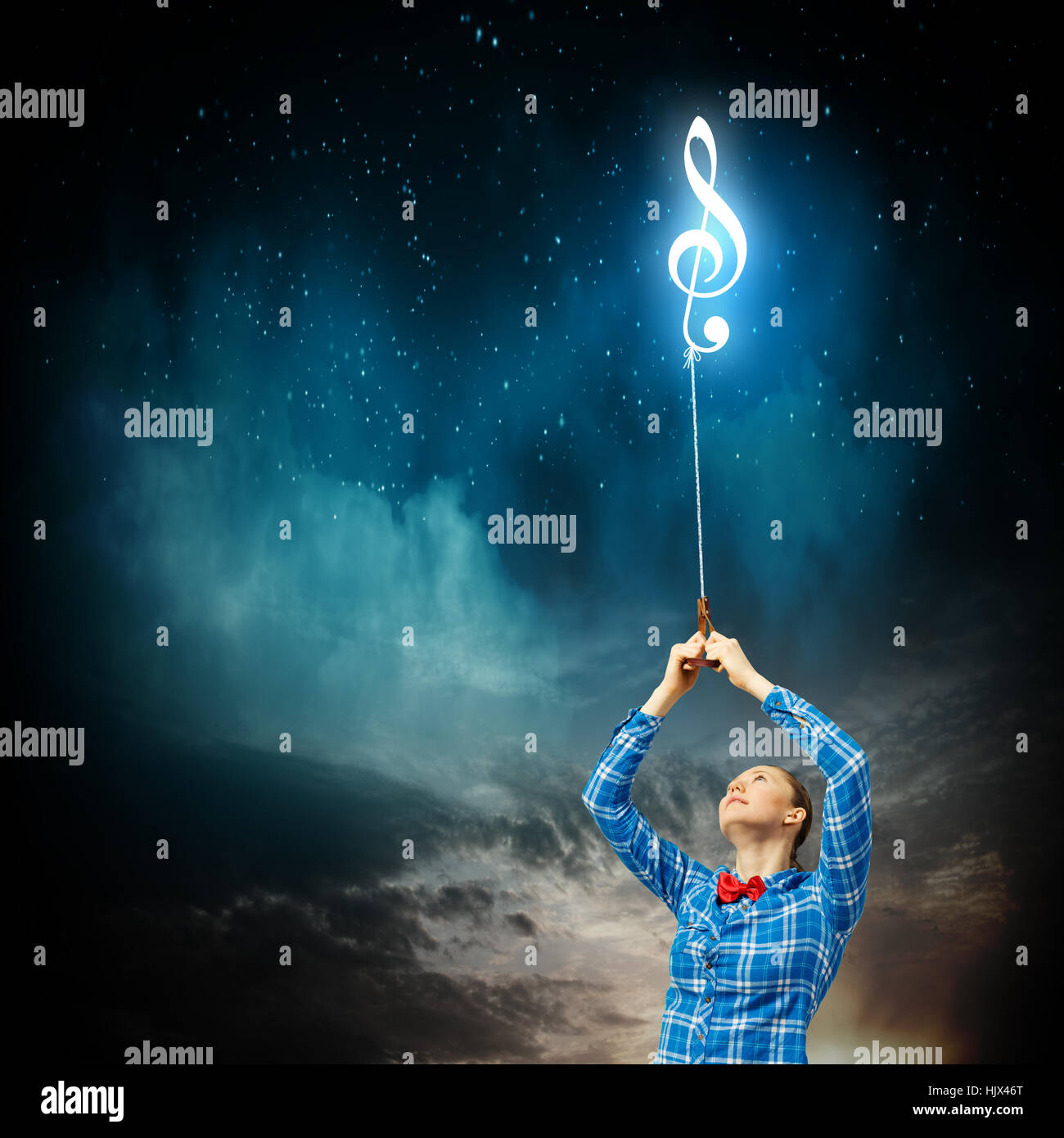 Giovane donna tenendo premuto segno musicale sulla corda Foto Stock