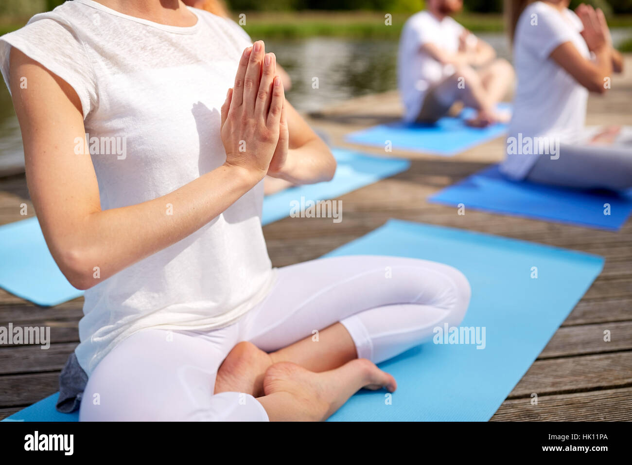 In prossimità di persone a fare esercizi di yoga all'aperto Foto Stock