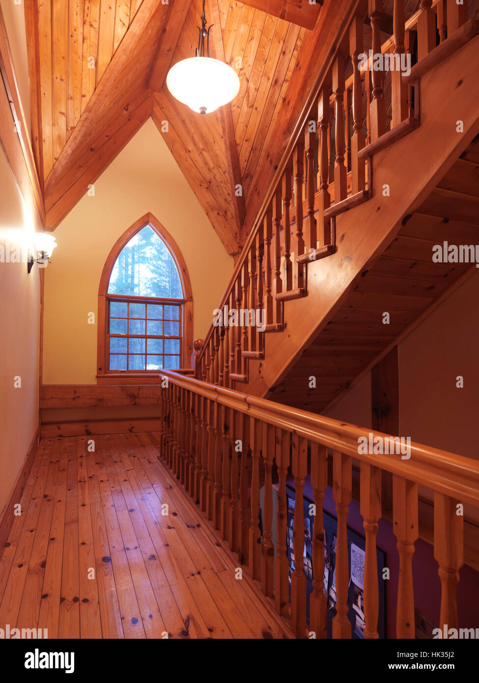 In legno in stile cottage Canadian country house hall interno con una scala in legno e un ad arco gotico Duomo finestra, Muskoka, Ontario, Canada Foto Stock