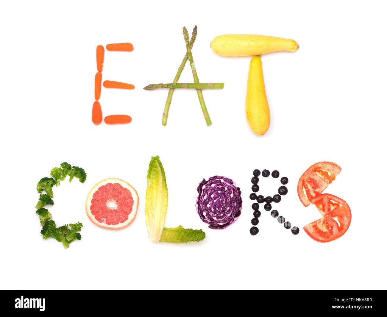 Mangiare i colori - testo enunciato in colorate alimenti vegetali; concetto di mangiare sano, su bianco Foto Stock