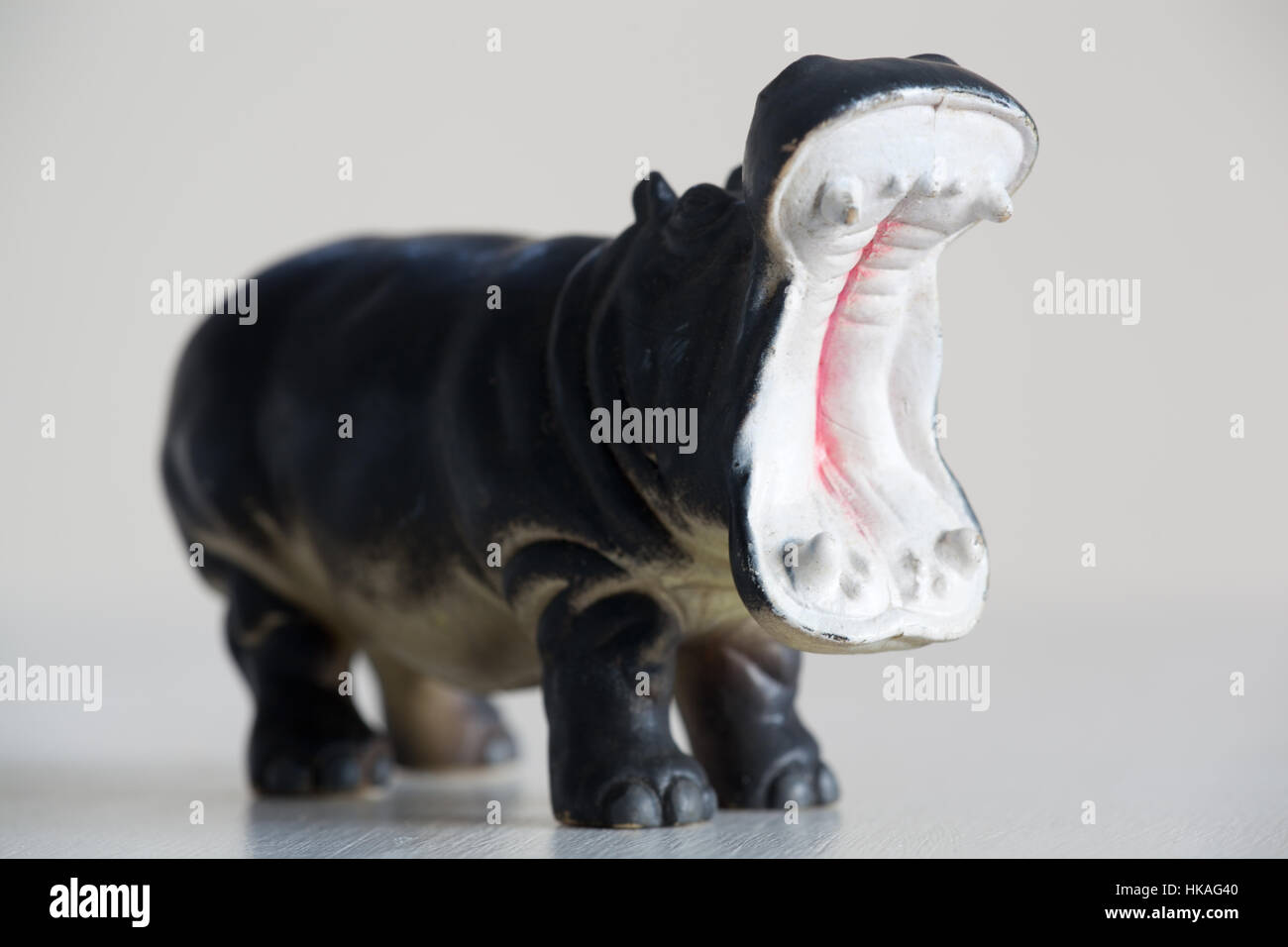 Un modello di plastica ippona con la sua bocca aperta in piedi su un terreno bianco Foto Stock