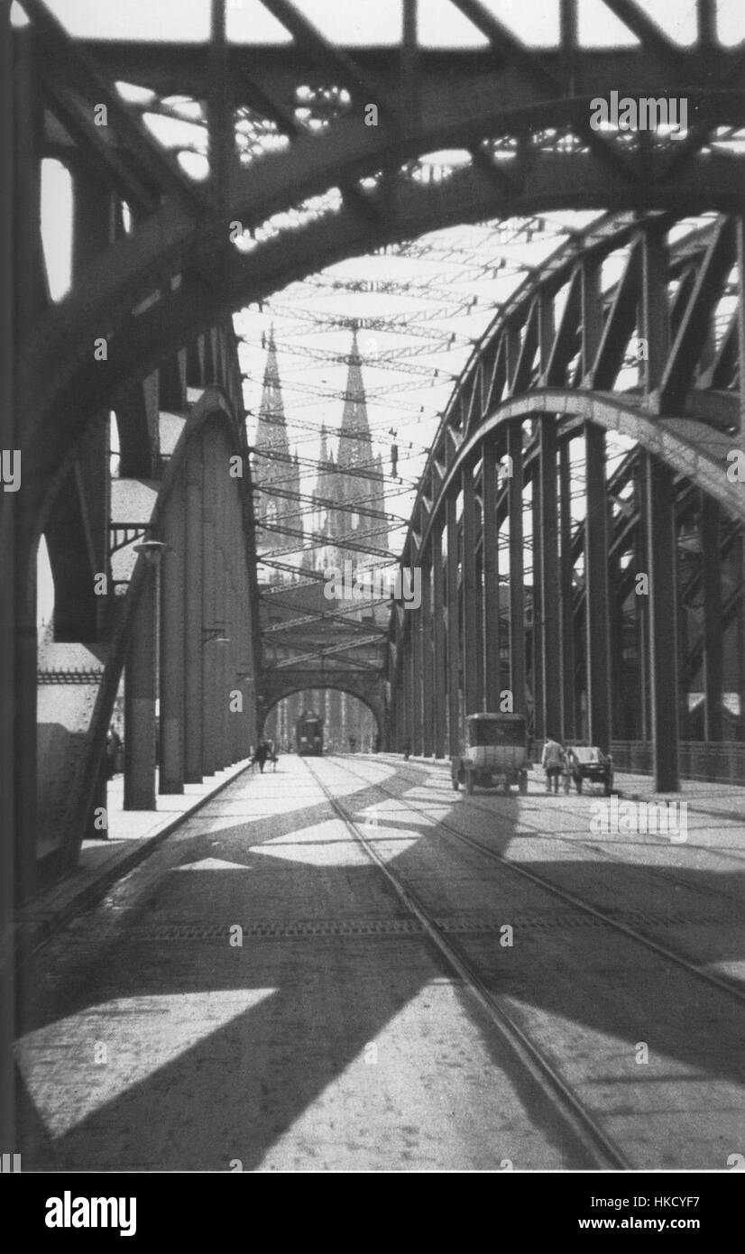 Questa fotografia storica di Oskar Barnack cattura l'iconico ponte e la cattedrale di Colonia, mostrando la grandiosità architettonica e il significato di questi luoghi di interesse a Colonia. Foto Stock