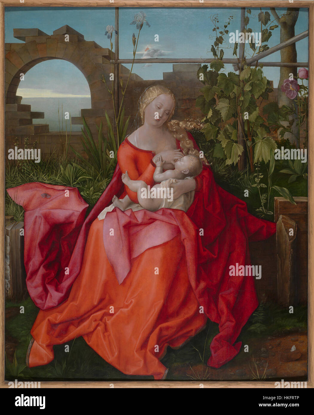 *La Madonna con l'Iris* è un dipinto ad olio che raffigura la Vergine Maria che regge un Iris, simboleggiando la purezza e il divino. L'opera combina temi classici e religiosi, tipici dell'arte rinascimentale. Foto Stock