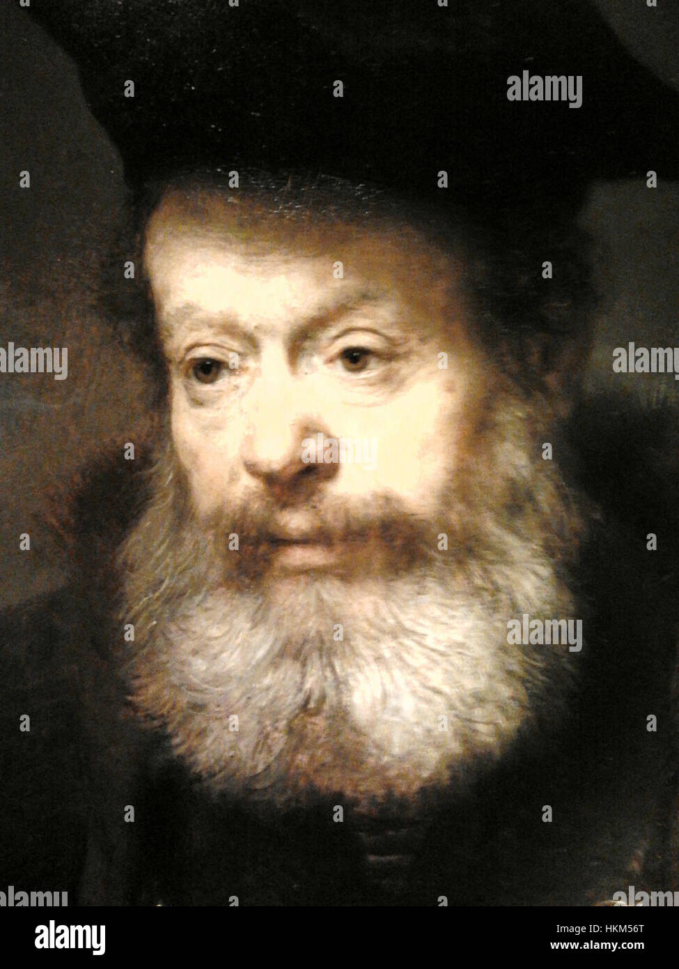 Questo lavoro dettagliato di Rembrandt mostra uno studioso in un leggio, che riflette la maestria dell'artista nel ritrarre soggetti intellettuali. Il dipinto ad olio evidenzia l'uso di luce e ombra, una tecnica distintiva di Rembrandt. Foto Stock