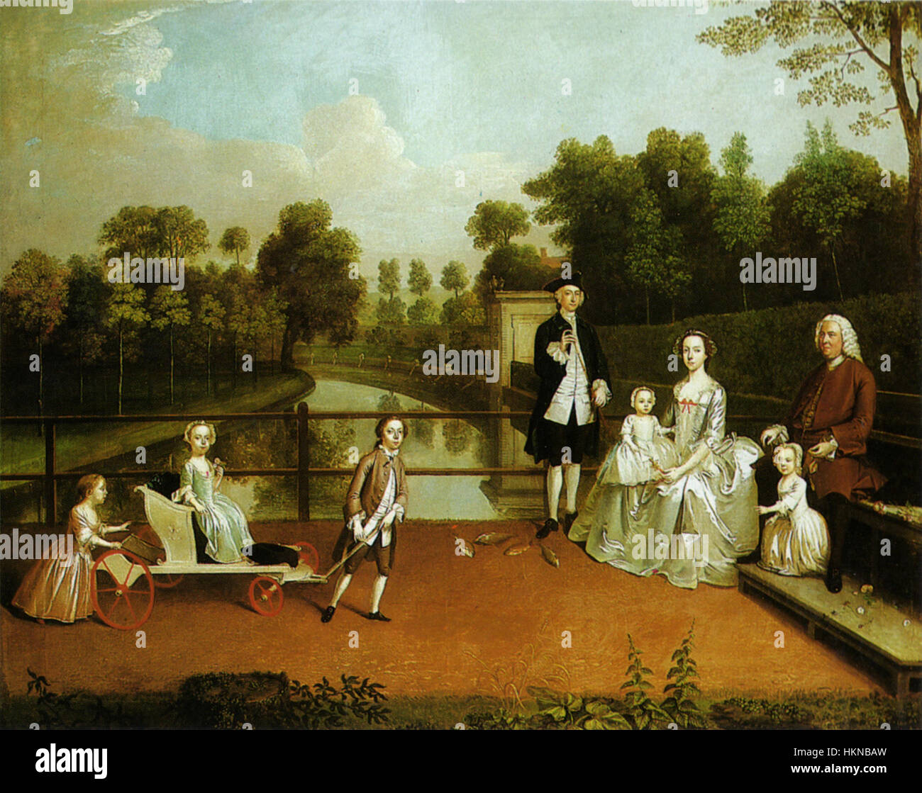 Questo dipinto ad olio di Arthus Devis del 1749 raffigura la famiglia Thomas Cave, catturando la moda storica e le relazioni familiari del tempo. L'opera riflette lo stile ritratto del XVIII secolo. Foto Stock