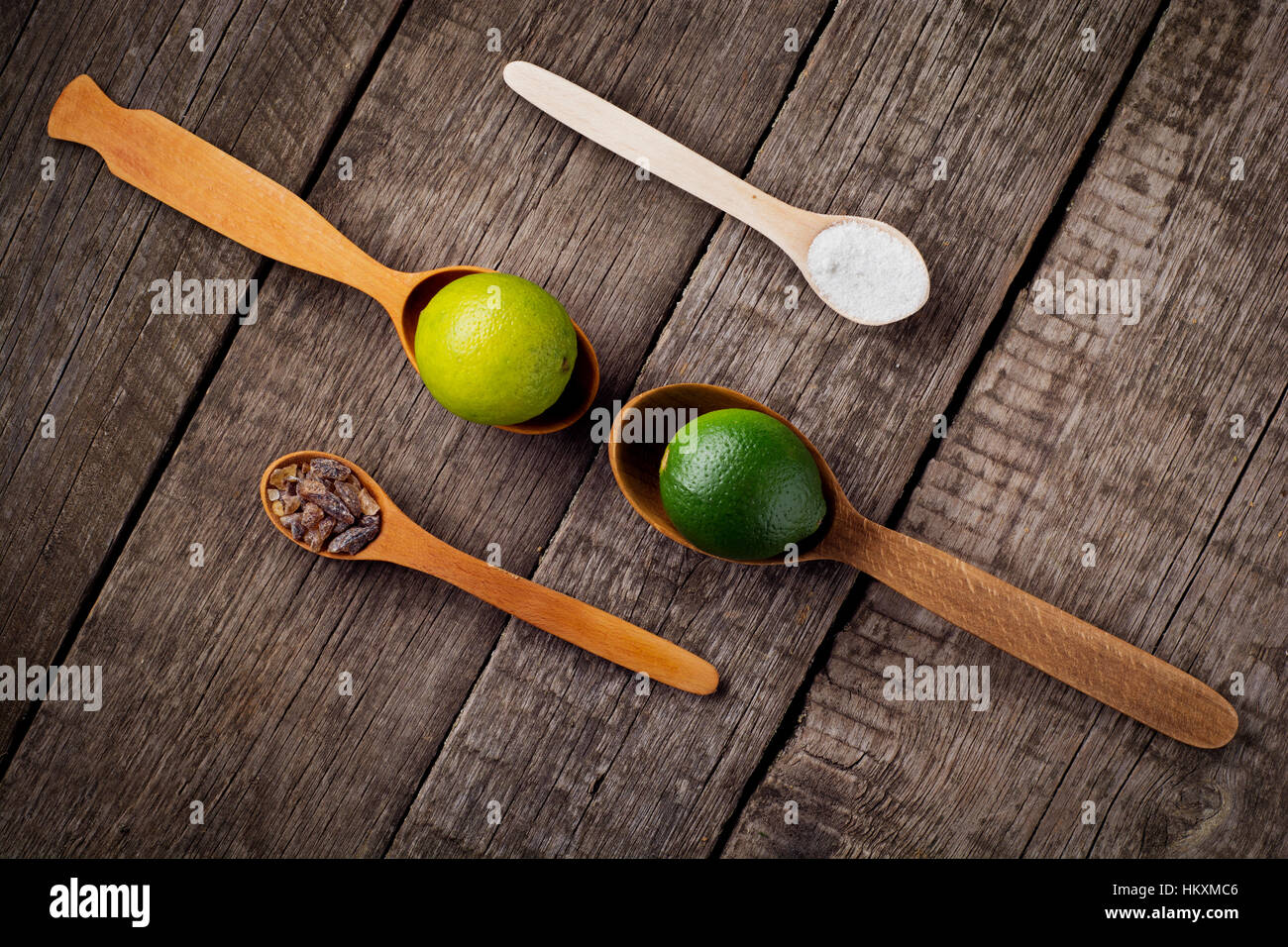 Lime sul cucchiai con sale e zucchero cucchiaio sul tavolo della cucina. Foto Stock