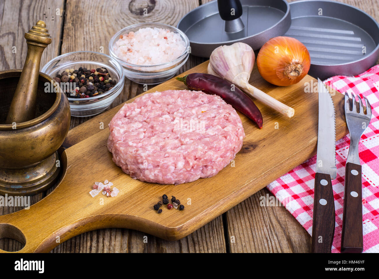 Carni macinate per la cottura di hamburger sul pannello di legno Foto Stock