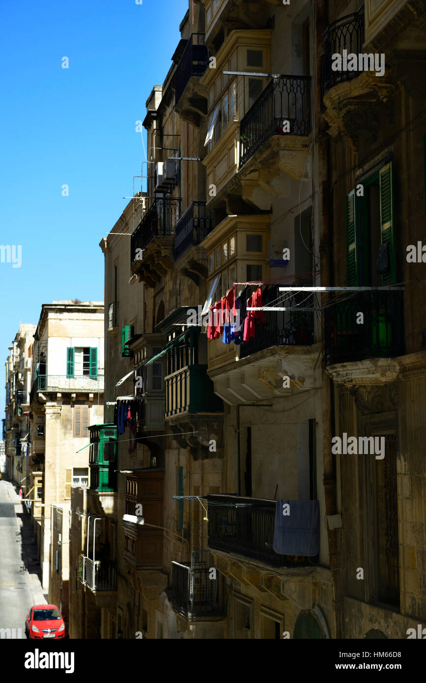 Asciugatura all'aperto a secco appendere appeso tradizionale stile vecchio legno balcone in legno appartamenti le strade de La Valletta Malta RM Mondo Foto Stock