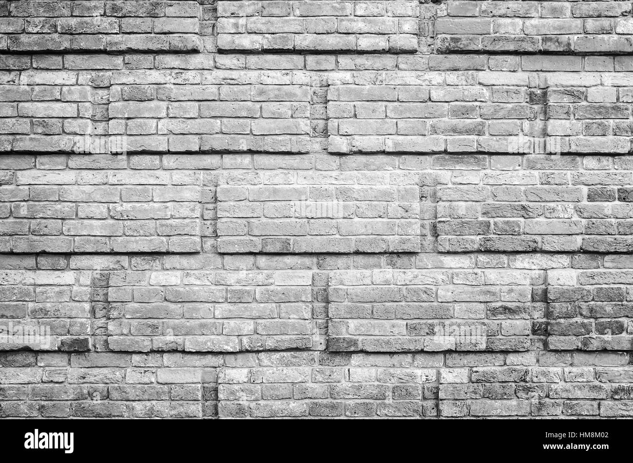 Grigio vecchio muro di mattoni con una decorazione rectanglular modello a rilievo, foto di sfondo texture Foto Stock