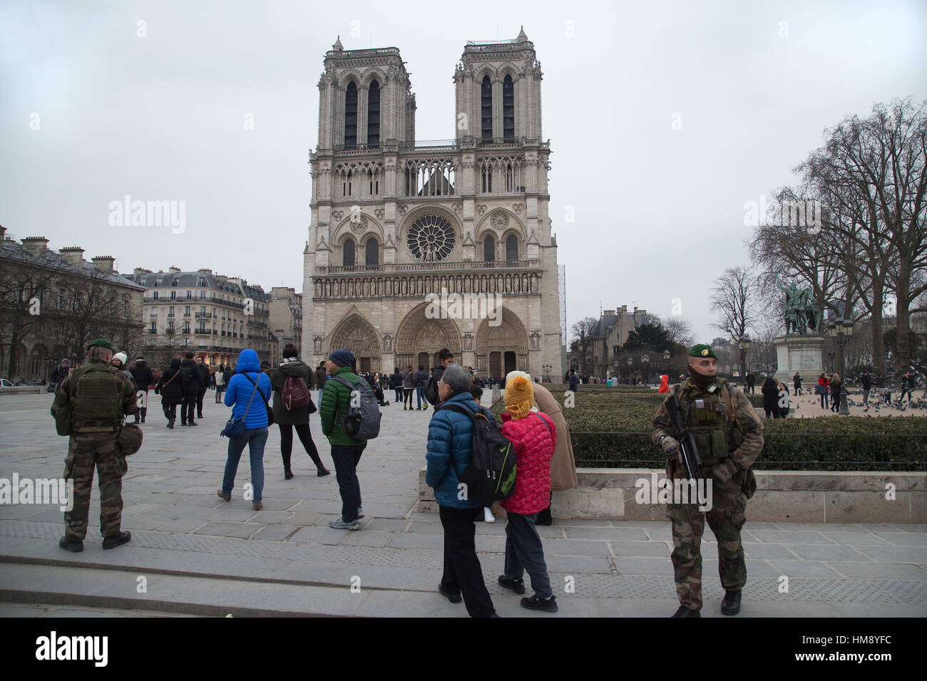 Soldati armati pattugliano intorno alla cattedrale di Notre Dame a Parigi Francia in inverno Foto Stock