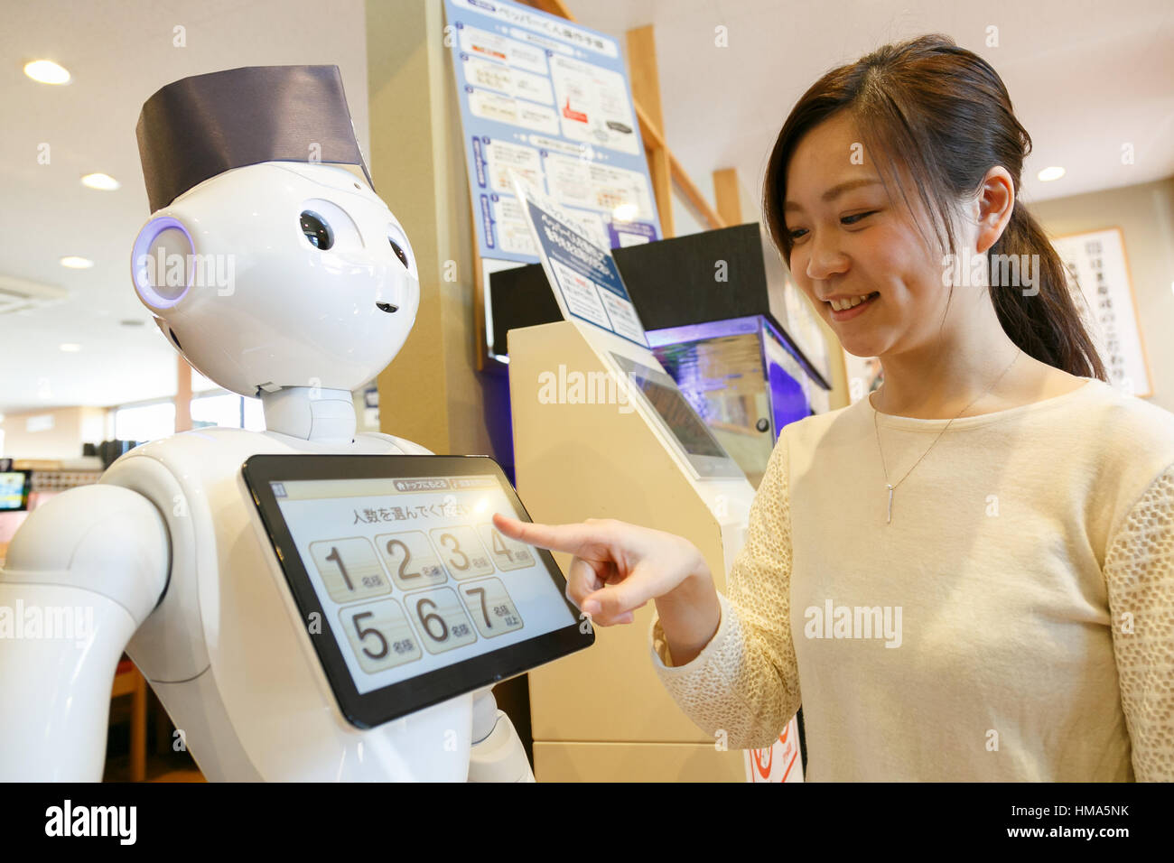 Tokyo, Giappone. 2° febbraio 2017. Un membro del personale dà una dimostrazione di pepe di robot come receptionist dell'Hamazushi nastro trasportatore ristorante di sushi in Saitama, appena a nord di Tokyo il 2 febbraio 2017, in Giappone. Il robot umanoide creato da SoftBank Robotics è in fase di collaudo da parte della catena di sushi di salutare, prendere tabella prenotazioni e lasciare che i clienti sappiano quando loro sedi sono pronti. Pepe è stata introdotta per migliorare la velocità di servizio al già altamente automatizzato di ristorante. Credito: Aflo Co. Ltd./Alamy Live News Foto Stock