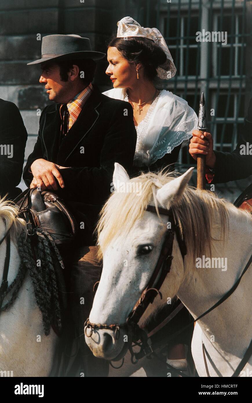 Uomo e donna che indossa abiti tradizionali a cavallo, Arles, Provence-Alpes-Côte d'Azur, in Francia. Foto Stock