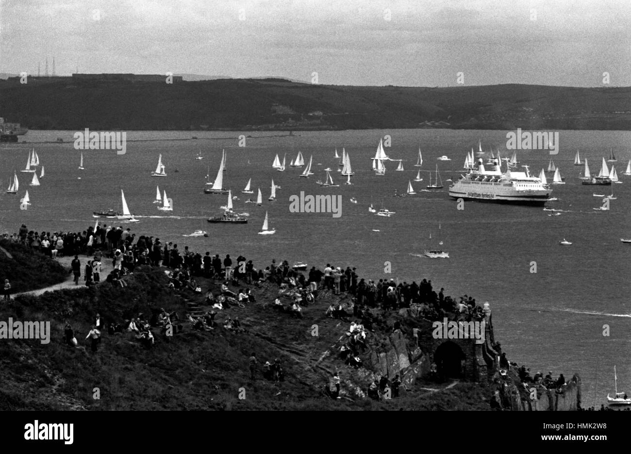 AJAXNETPHOTO. 7 Giugno, 1980. PLYMOUTH in Inghilterra. - OSTAR 1980 - con una sola mano - GARA - spettatori raccogliere sul promontorio a PENLEE affacciato sulla baia di CAWSAND per guardare la gara iniziare. Foto:JONATHAN EASTLAND/AJAX REF:800706 6 Foto Stock