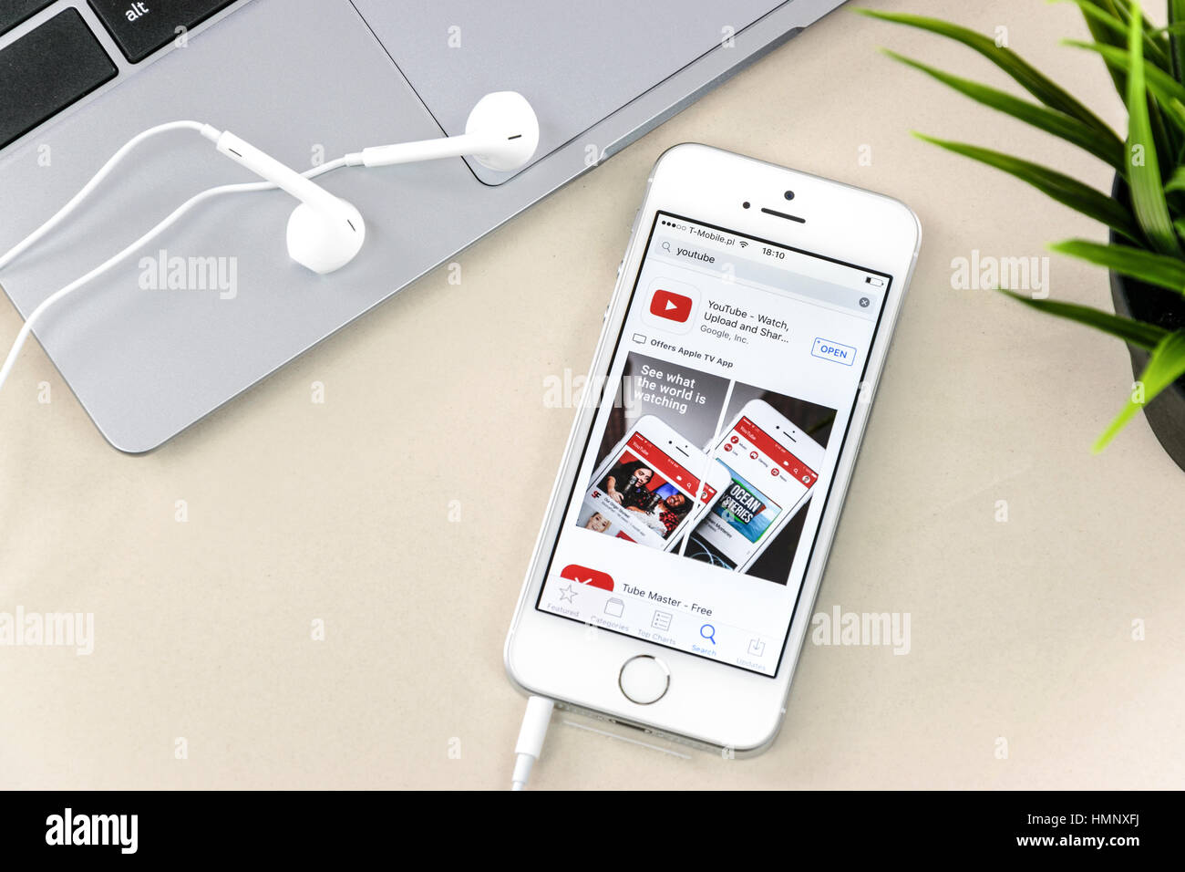 Krynica, Polonia - Febbraio 02, 2017: YouTube app su iPhone SE, vicino a un computer portatile. YouTube è uno dei più popolari video sharing service app sul Foto Stock