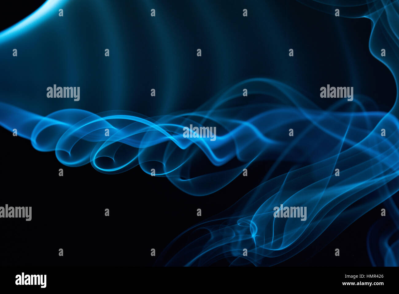 Blu fumo ricci linee isolate su nero Foto Stock