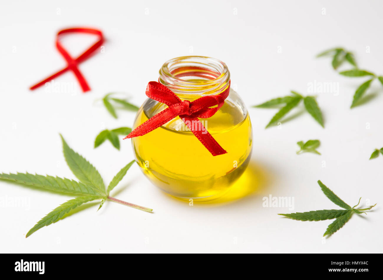 Foglie di cannabis e olio su sfondo bianco Foto Stock