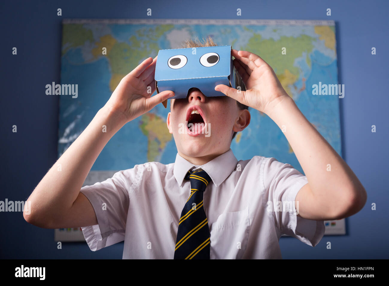 Un alunno di esplorare il mondo attraverso un VR Virtual Reality auricolare Foto Stock