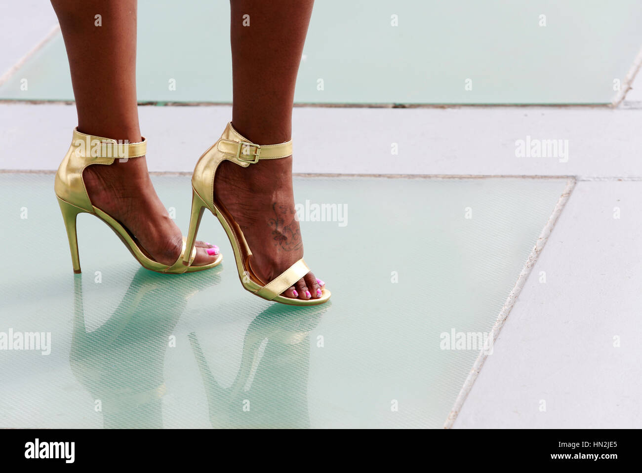Le gambe della bella African American woman in golden tacchi alti scarpe, centro di Austin, Texas, Stati Uniti d'America Foto Stock