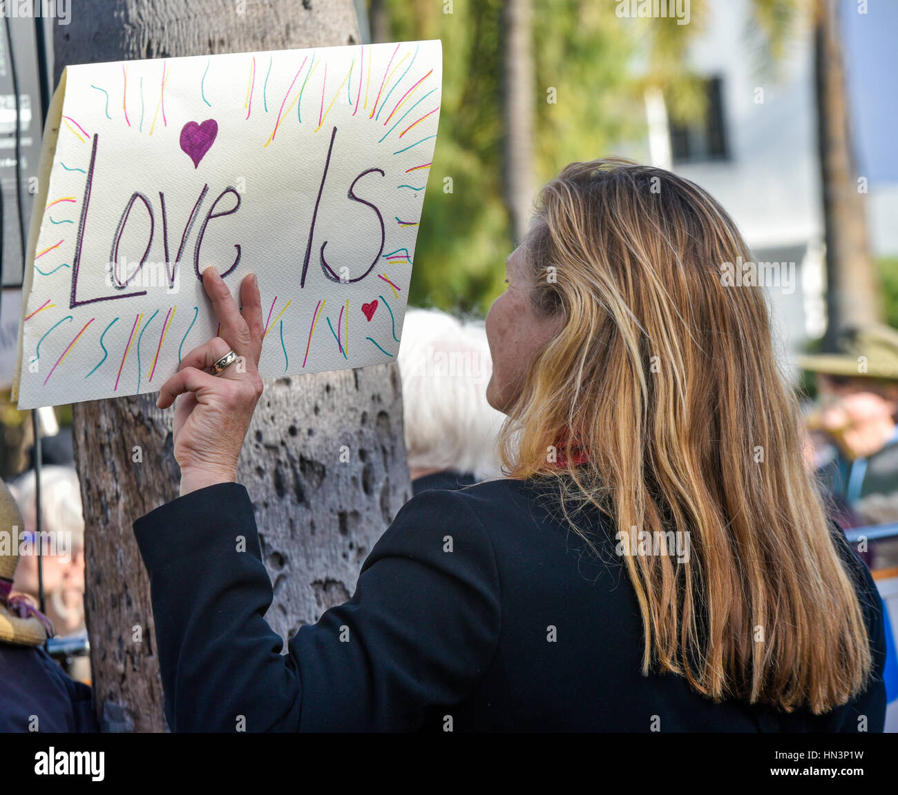 Il dimostratore portando un 'l'amore è " segni di un musulmano Anti Divieto di viaggiare nel rally di Santa Barbara, CA Foto Stock