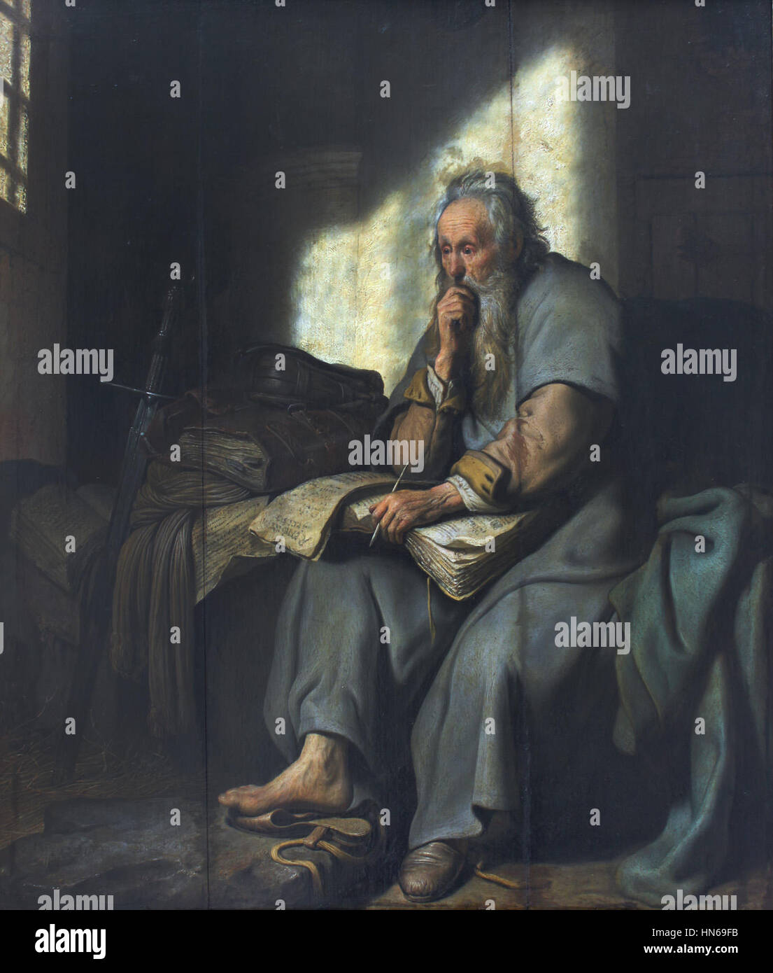 Nel 1627 di Rembrandt 'Paulus im Gefängnis' (Paolo in prigione), l'artista raffigura una drammatica scena biblica dell'apostolo Paolo in prigione. L'opera d'arte cattura l'uso caratteristico di luce e ombra di Rembrandt, concentrandosi sull'intensità emotiva e sull'isolamento della figura. Foto Stock