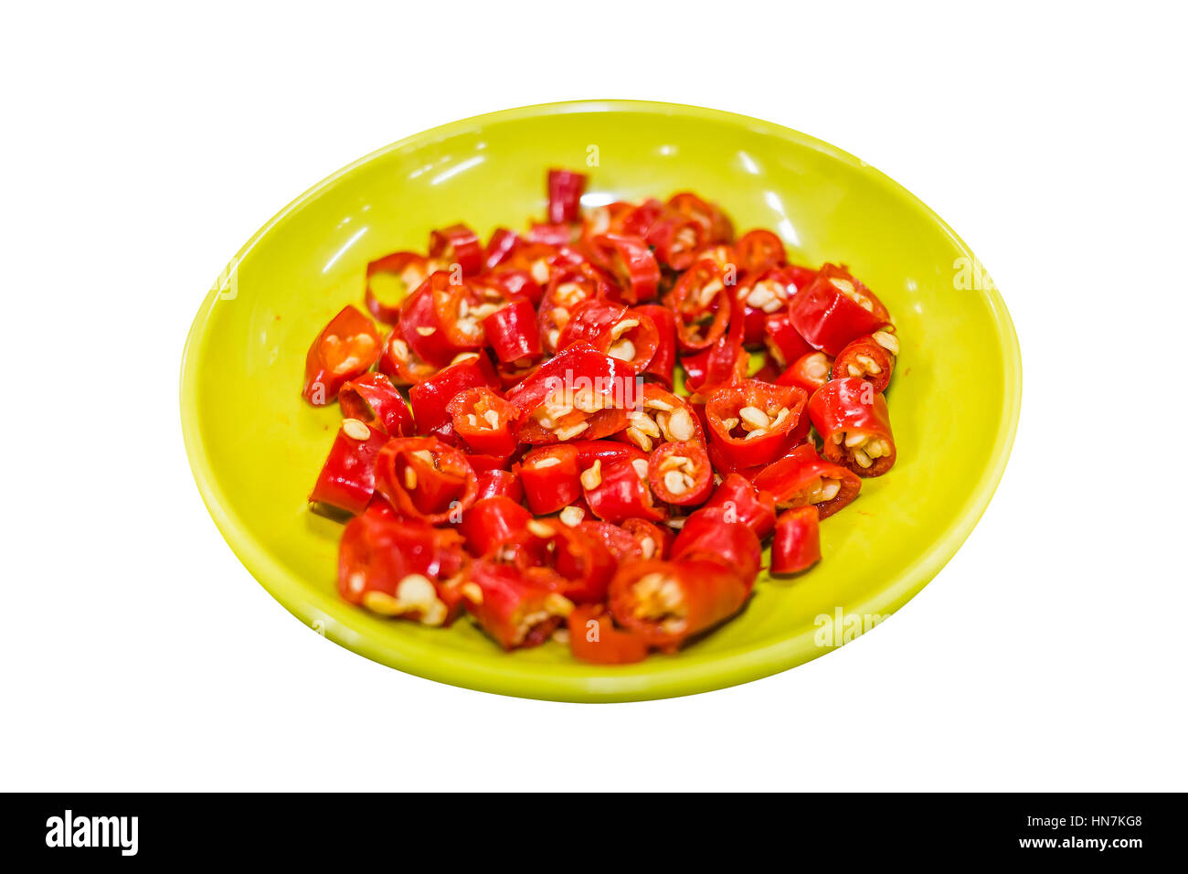 Peperoncino tagliato a fette nel piatto giallo isolato, Red Hot Chili fetta, piccante peperoncino tailandese nella vaschetta di colore giallo su sfondo bianco, ingrediente asiatica Foto Stock