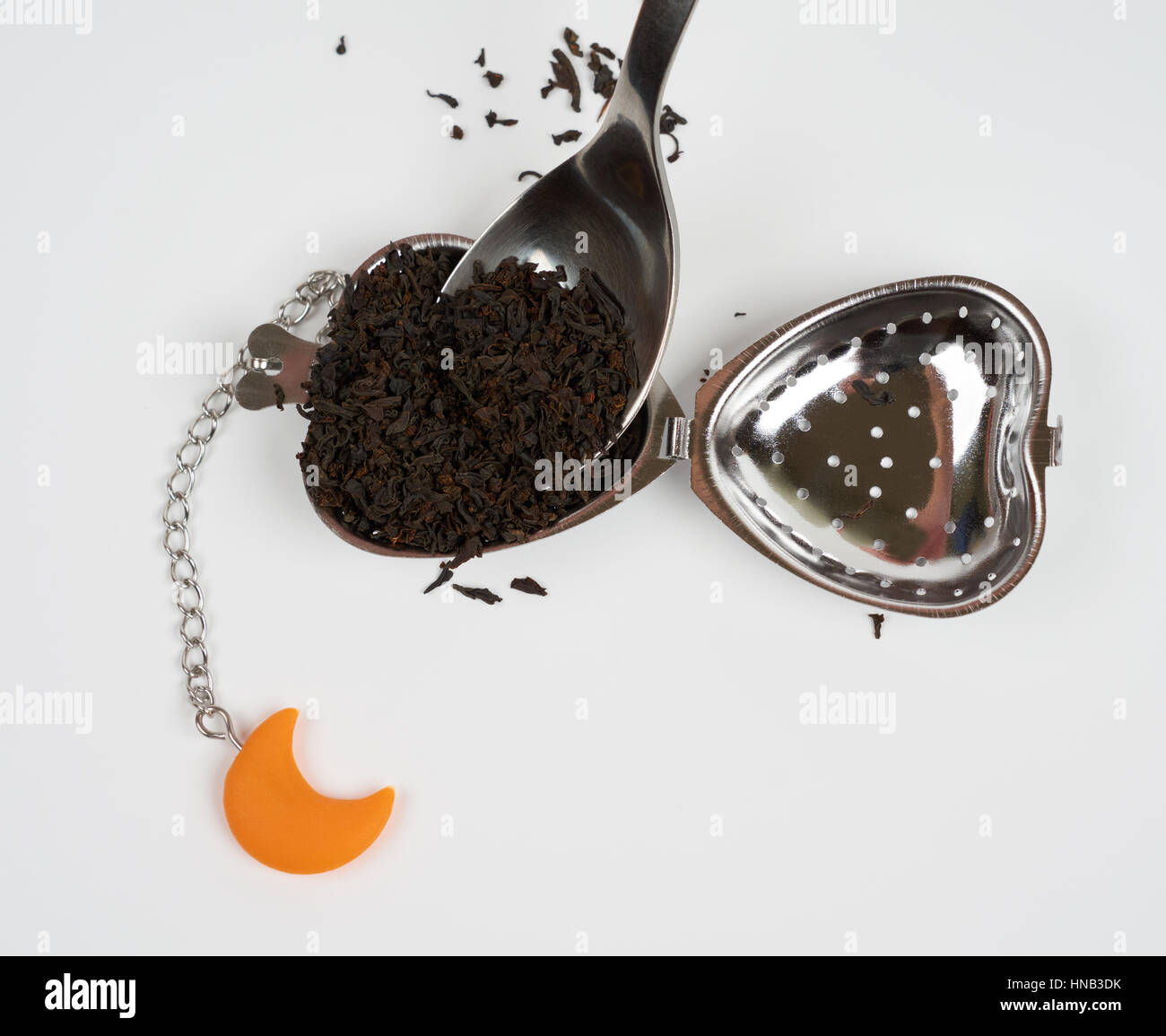 Mettere un cucchiaio di tè nero nel filtro di tè Foto Stock