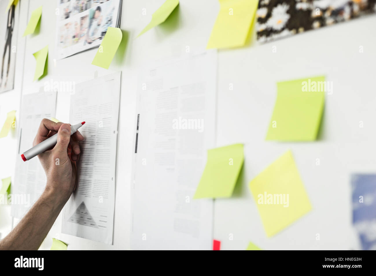 Immagine ritagliata di imprenditore il la scrittura a mano su un foglio di carta in ufficio Foto Stock
