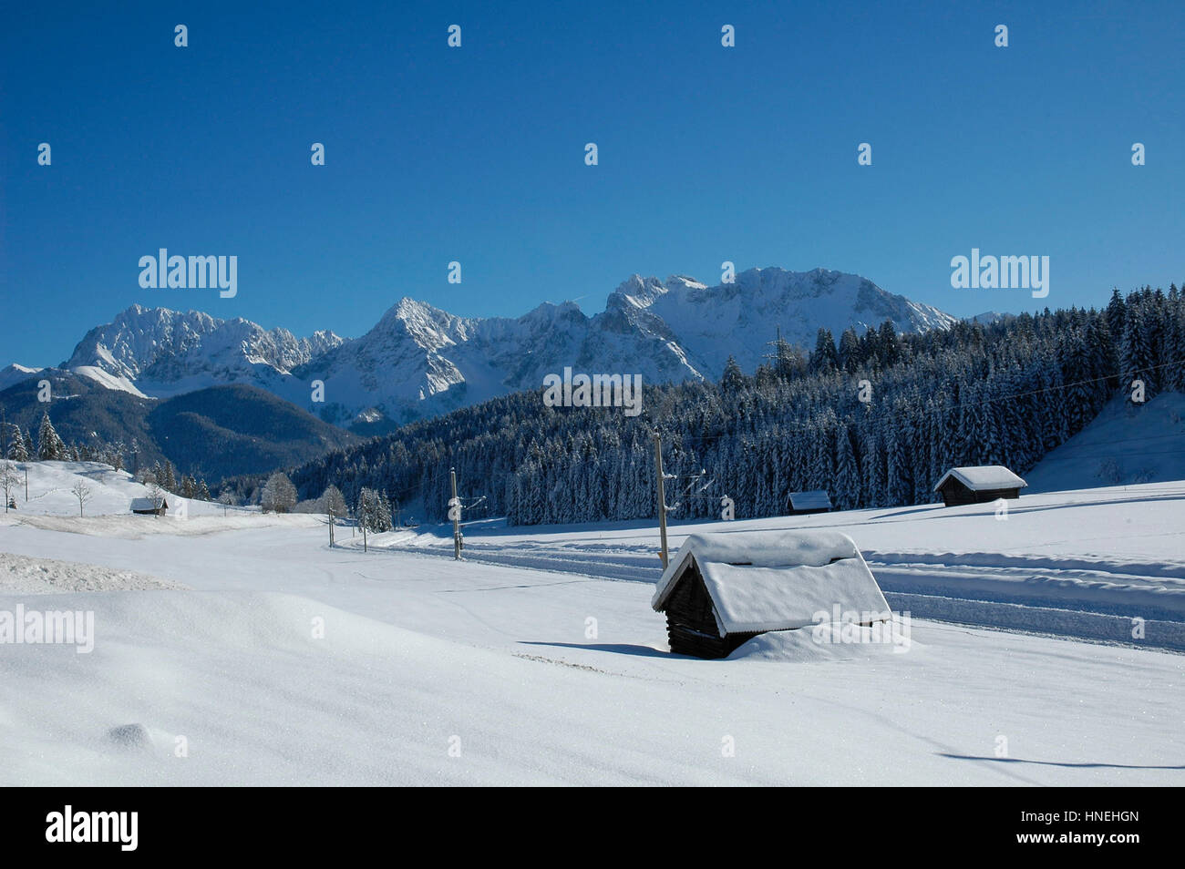 Vista della Scenic paesaggio invernale nelle alpi bavaresi con la famosa basilica di San Pietro e Paolo Chiesa in Mittenwald Città Alta Baviera, Germania. Un sacco di neve. Foto Stock