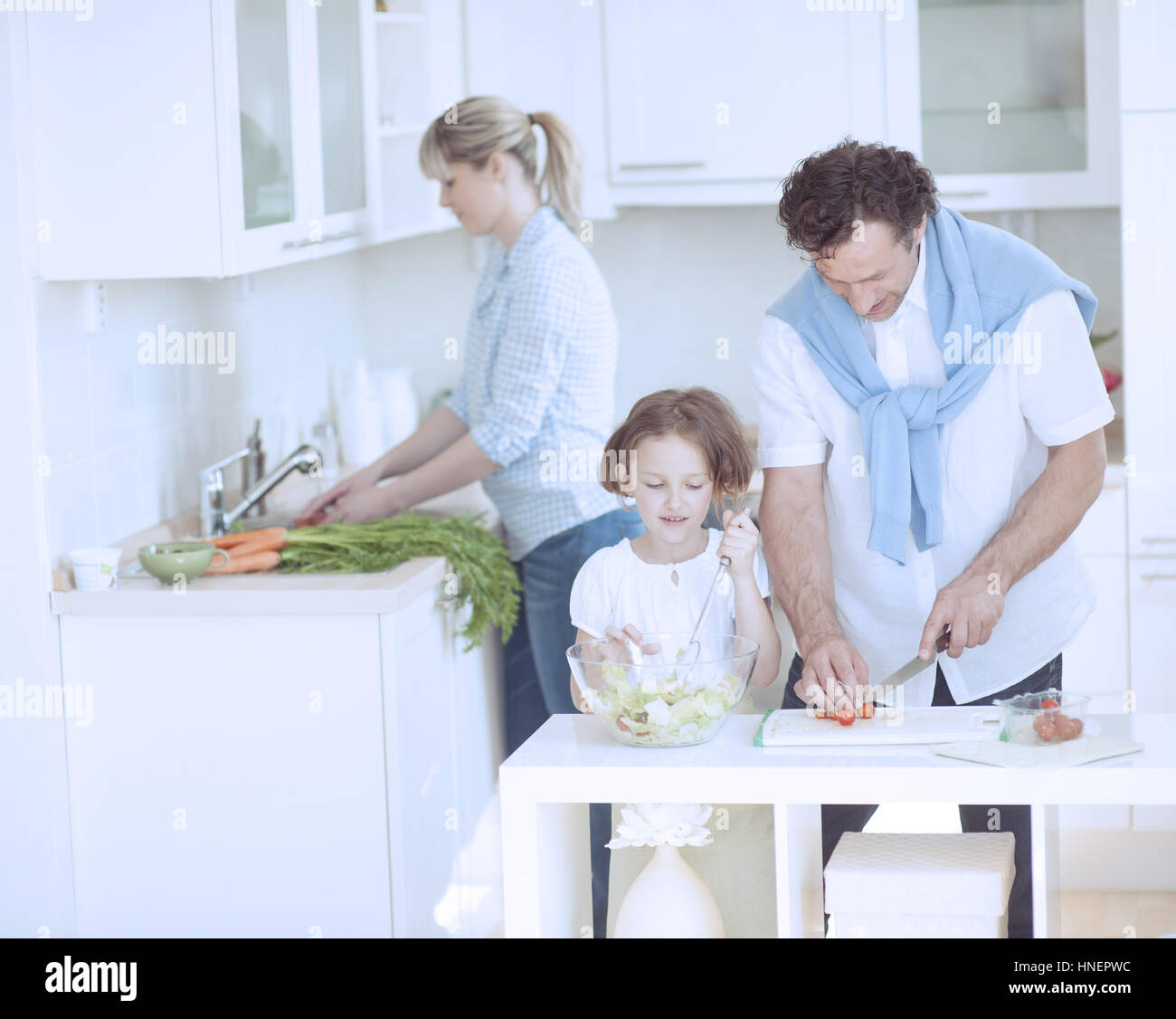 La famiglia la preparazione di pasto sano in cucina Foto Stock