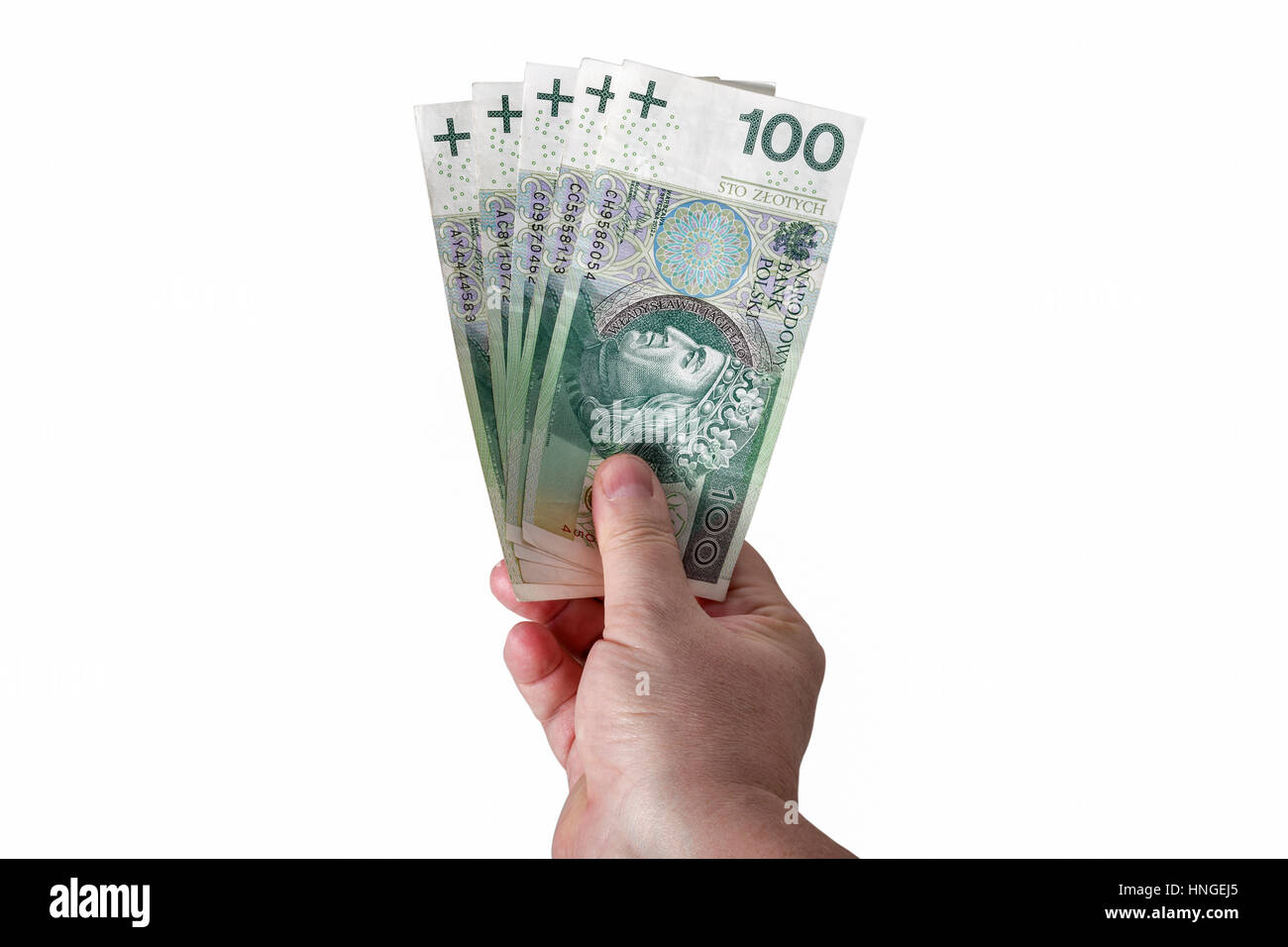Man mano che tiene lo zloty polacco cento banconote isolati su sfondo bianco closeup Foto Stock