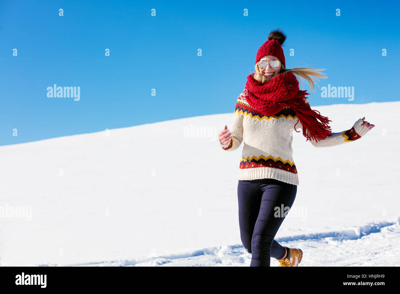 Esecuzione di donna runner in montagne invernali sulla neve. Foto Stock