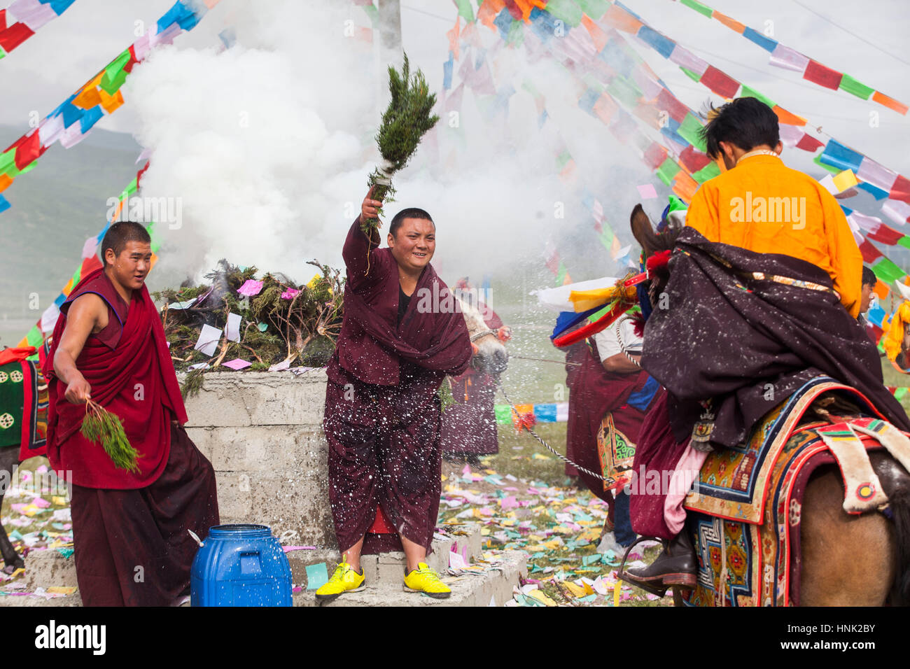 Monaci buddisti tibetani riprodurre strumenti tradizionali di benedire i piloti del Cavallino prima racing al Manigango Horse Festival alta nella Platea tibetano Foto Stock