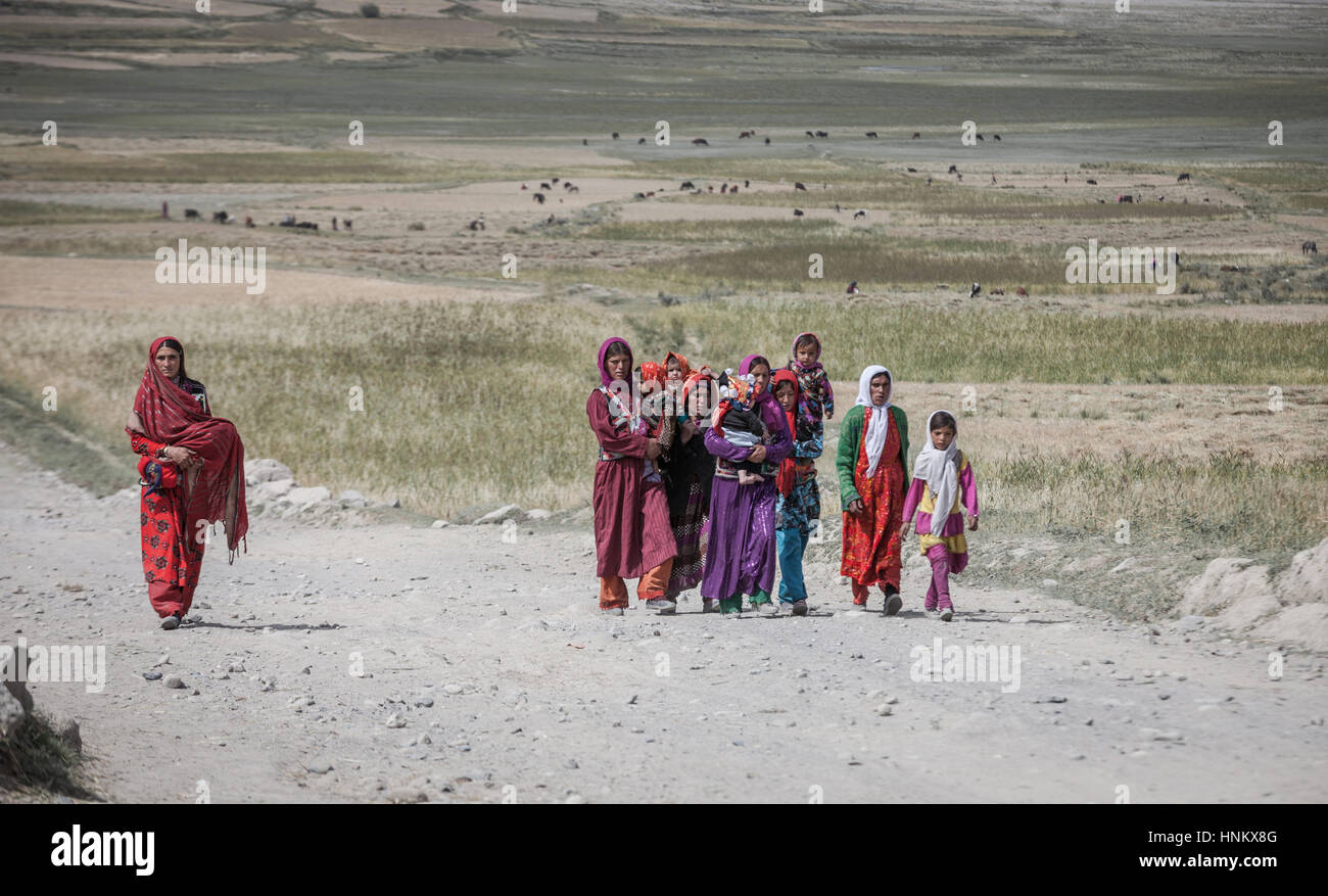 Afghanistan, Wahkan corridoio, una famiglia passeggiate nella valle con bambini tornando dalla raccolta di fieno per l'inverno. Foto Stock