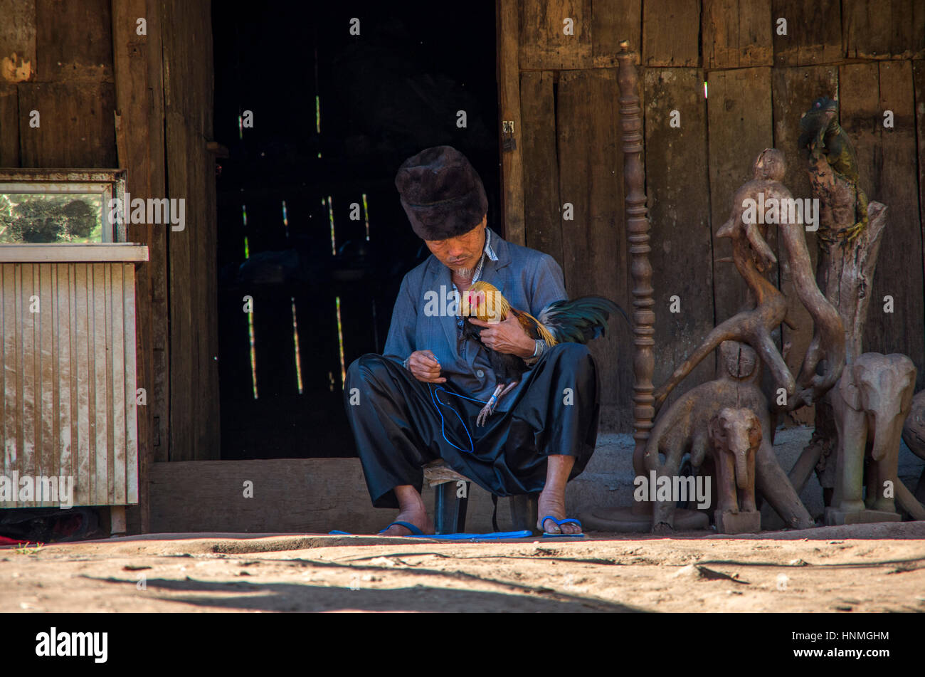 L'uomo con il suo gallo pet al villaggio hmong in Chiang Mai, Thailandia. Foto Stock