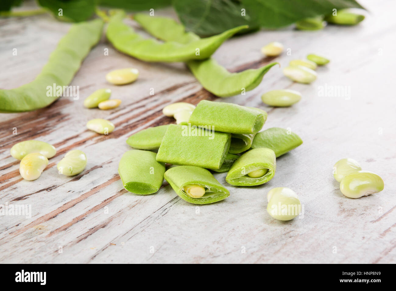 Fette di fagioli verdi su bianco tavolo in legno. Legume sano di mangiare. Foto Stock