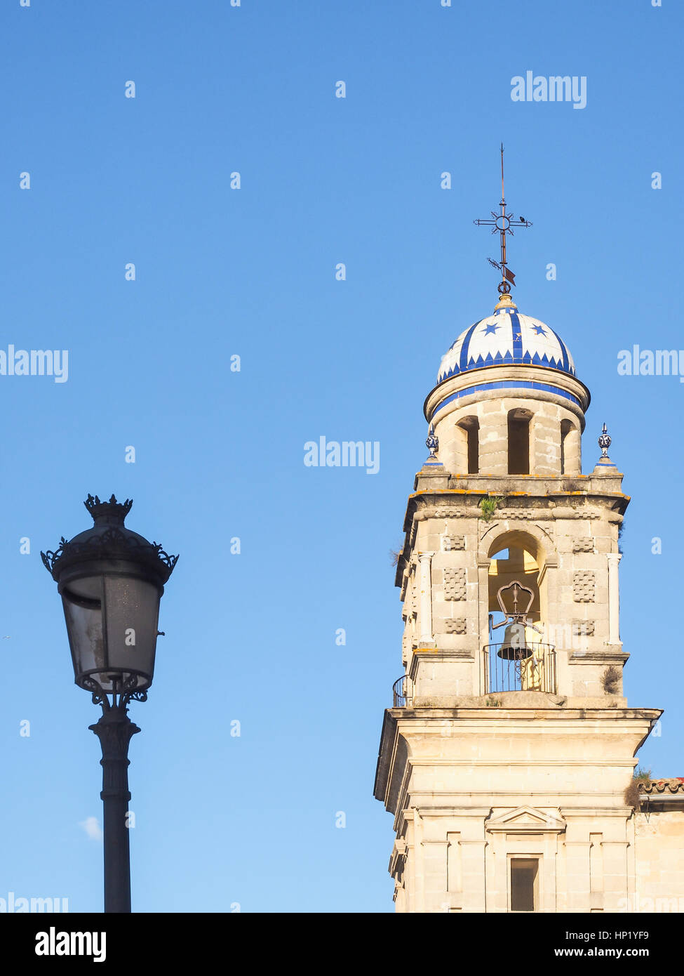 La torre della cattedrale di Jerez de la Frontera con strada lampada frontale del cielo blu Foto Stock