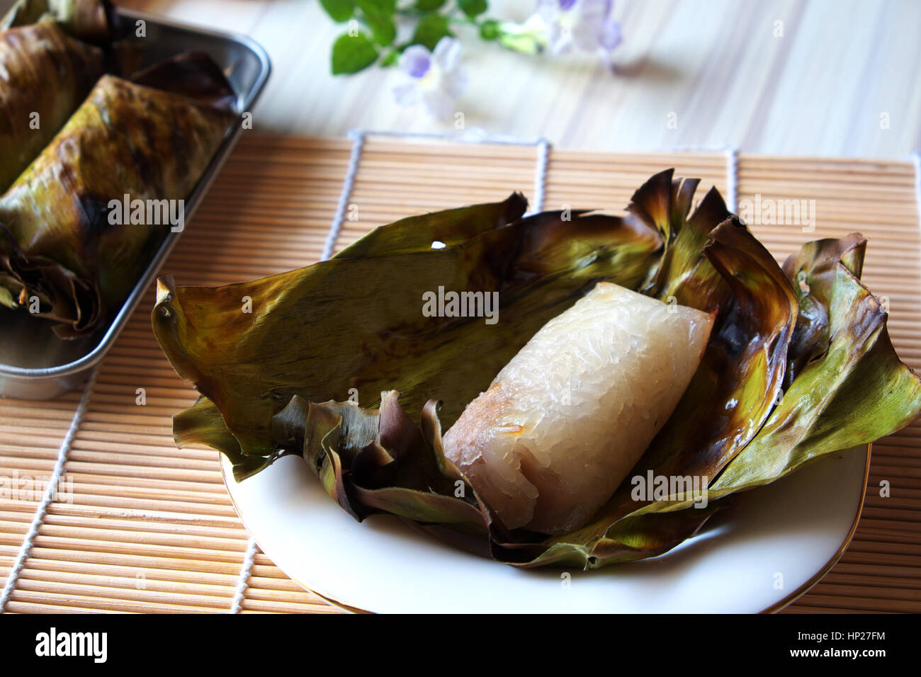 Khao Ping nio è arrosto dolci di riso appiccicoso con il latte di cocco e il taro all'interno di riempimento, su foglie di banano. Treditional Thai dessert di stile. Foto Stock