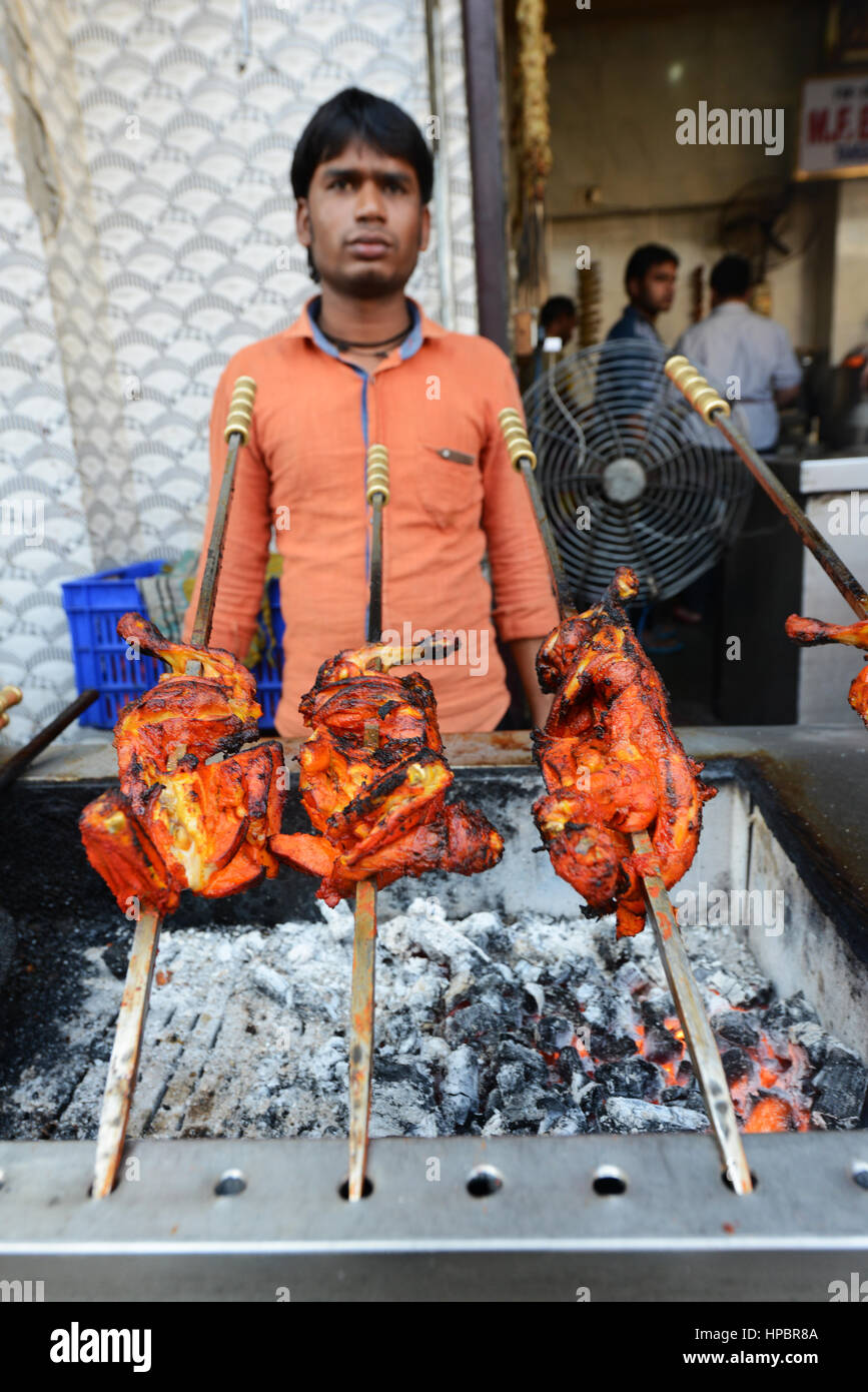 Pollo Tandoori preparati al di fuori di un ristorante in Aminabad area di mercato nella città di Lucknow, India. Foto Stock