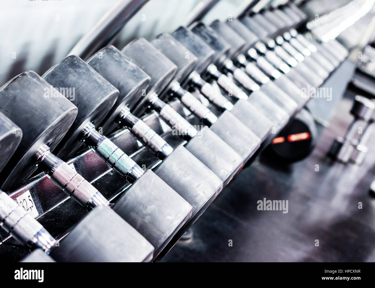 Le righe dei pesi nella palestra con altissimo contrasto e monocromatico colore tono. Spazio di copia Foto Stock